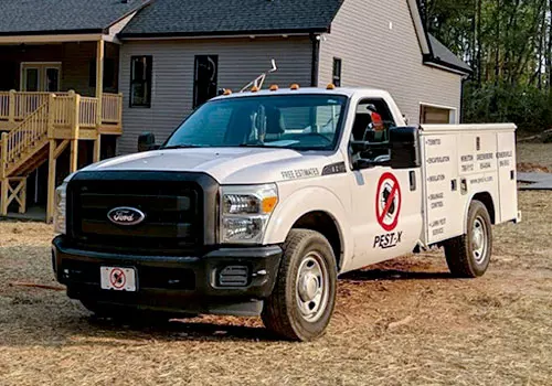 Pest-X Truck in front of a house